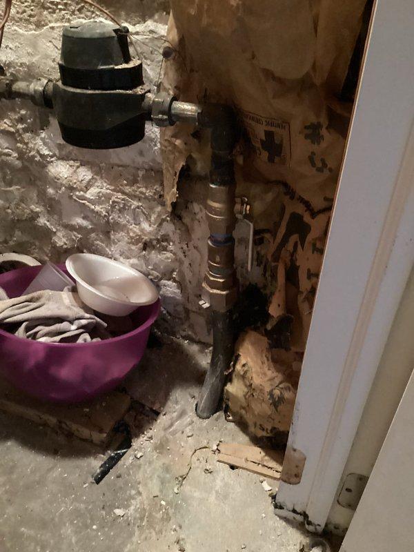 Conducted comprehensive all-day plumbing inspection of utility area revealing extensive deterioration of existing plumbing infrastructure, including corroded metal piping, damaged valve assemblies, and significant water damage to surrounding wall surfaces. Documented conditions with photographic evidence showing compromised plumbing fixtures, deteriorated wall materials with moisture staining, and noted immediate need for hot water service restoration. Identified critical repair requirements including replacement of corroded piping components and remediation of water-damaged structural surfaces in basement utility area.