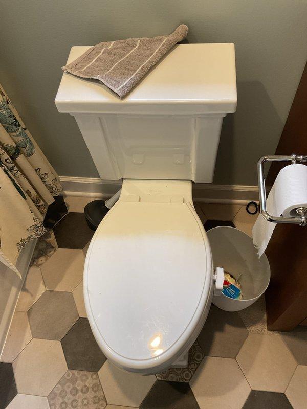 Responded to service call for toilet draining slowly despite customer's attempts to clear with plunger. Upon arrival, inspected toilet and bathroom plumbing system. Evaluated drainage performance and identified blockage in toilet trap. Utilized professional-grade closet auger to clear obstruction from toilet drain line. Removed blockage and restored proper drainage flow. Tested toilet multiple times to verify complete clearance and confirm water drains at normal rate. Inspected utility room plumbing connections and water supply lines to ensure no related issues. All fixtures operating properly upon completion. Documented site conditions with photographs for service records.