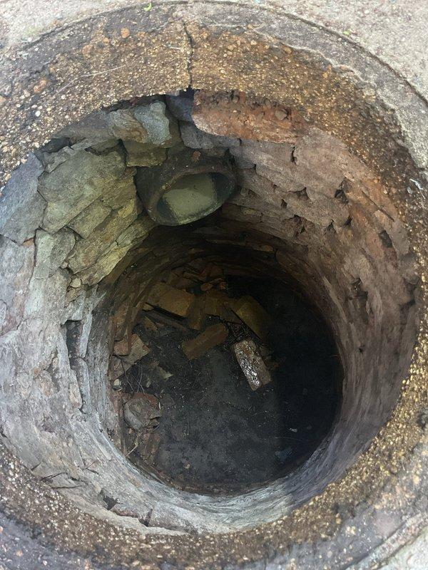 Responded to emergency service call for basement flooding following heavy rainfall due to suspected catch basin blockage. Performed thorough inspection of catch basin and underground drainage system, documenting significant debris accumulation and deterioration of concrete structure. Rodded catch basin to clear blockage and restore proper drainage flow. Additionally addressed utility sink drainage issue in basement, clearing slow drain to restore normal operation. Inspected basement plumbing infrastructure, noting rust staining on vertical PVC drainage pipes and documented overall condition of mechanical room plumbing connections.