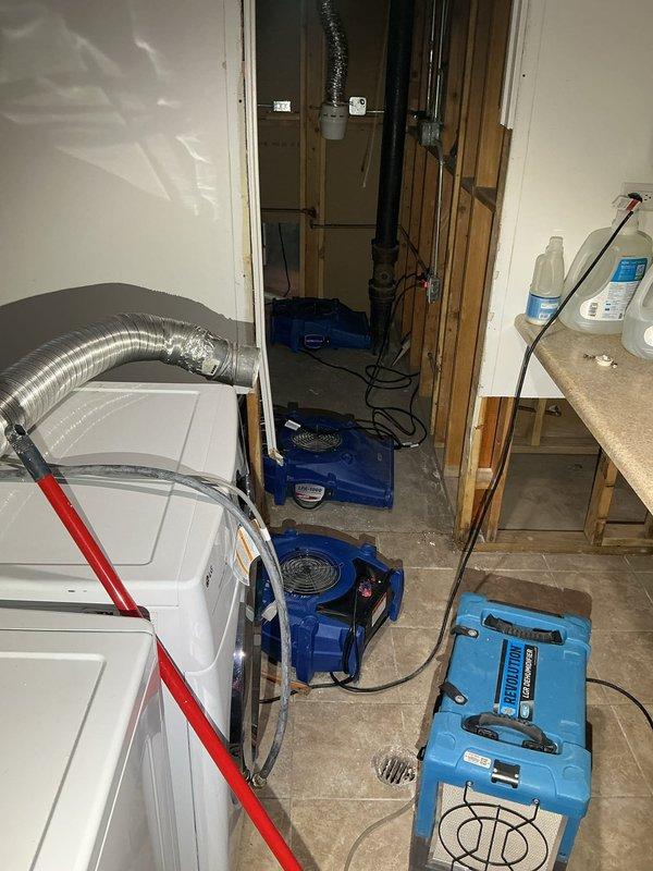 Responded to water damage emergency and deployed comprehensive flood control and moisture mitigation system. Removed compromised drywall sections to expose wall studs and assess extent of water intrusion. Strategically positioned multiple industrial air movers throughout affected rooms to facilitate rapid air circulation and moisture evaporation. Installed commercial-grade dehumidification unit to extract ambient moisture from the air and building materials. Configured proper ventilation and airflow patterns extending through multiple rooms to ensure thorough drying of all impacted areas.
