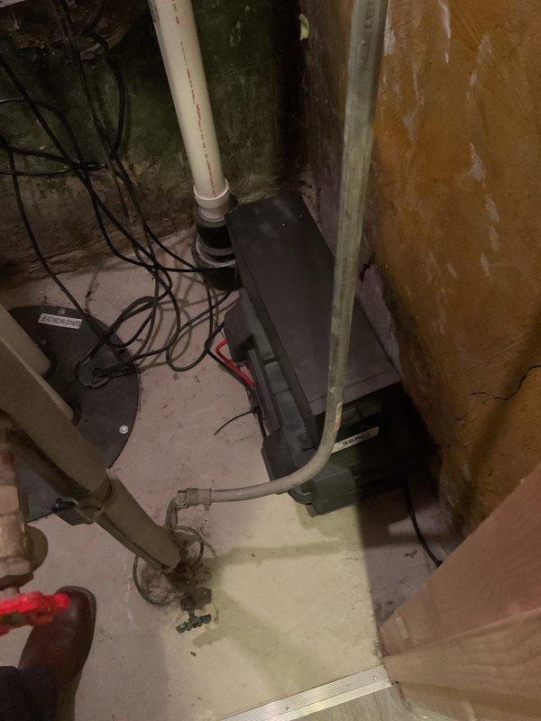 # Sump Pump Chirping Noise Diagnosis and Repair

Responded to service call for chirping noise emanating from sump pump system in century-old residential property. Upon arrival, conducted thorough inspection of sump pump installation located in basement utility area. Visual assessment revealed battery backup system with connected wiring harness and primary pump assembly with vertical PVC discharge piping.

Identified chirping sound originating from battery backup alarm indicator, signaling low battery voltage or connection issue. Inspected battery terminals and wiring connections, noting corrosion on terminal contacts. Testing confirmed backup battery had reached end of service life and required replacement.

Examined primary sump pump operation by manually activating float switch mechanism. Pump engaged properly with normal motor sound and adequate discharge flow through PVC piping system. Verified check valve operation and confirmed no backflow issues.

Assessed overall system conditi