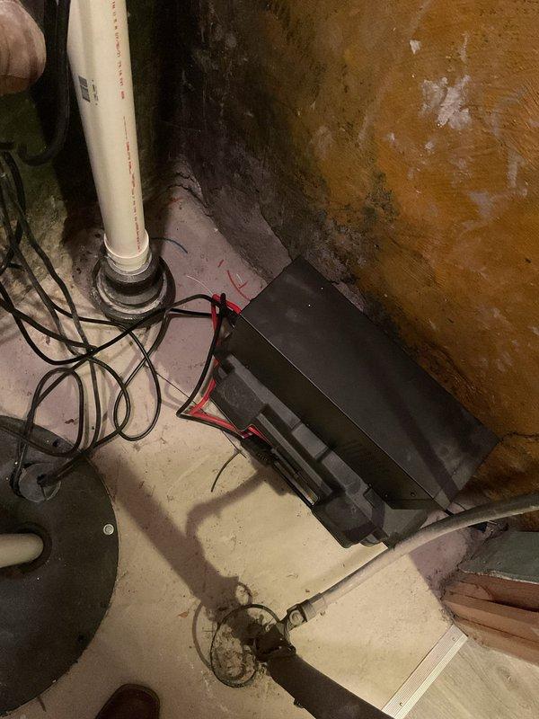 # Sump Pump Chirping Noise Diagnosis and Repair

Responded to service call for chirping noise emanating from sump pump system in century-old residential property. Upon arrival, conducted thorough inspection of sump pump installation located in basement utility area. Visual assessment revealed battery backup system with connected wiring harness and primary pump assembly with vertical PVC discharge piping.

Identified chirping sound originating from battery backup alarm indicator, signaling low battery voltage or connection issue. Inspected battery terminals and wiring connections, noting corrosion on terminal contacts. Testing confirmed backup battery had reached end of service life and required replacement.

Examined primary sump pump operation by manually activating float switch mechanism. Pump engaged properly with normal motor sound and adequate discharge flow through PVC piping system. Verified check valve operation and confirmed no backflow issues.

Assessed overall system conditi