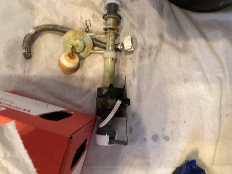 Responded to service call for toilet tank not filling properly with audible slow drip sound in tank. Upon inspection, identified failed fill valve assembly causing inadequate water flow and continuous dripping. Removed toilet tank lid and diagnosed worn internal components within the fill valve mechanism, including deteriorated seals and faulty float adjustment. Shut off water supply at angle stop and drained tank completely. Removed old brass fill valve assembly, which showed significant mineral deposits and corrosion consistent with the 25-year age of the home's plumbing fixtures. Installed new fill valve assembly with adjustable float mechanism and connected refill tube to overflow pipe. Adjusted water level to manufacturer specifications and tested flush cycle multiple times to ensure proper tank refill and shutoff function. Verified no leaks at tank-to-bowl connection and confirmed silent operation with no dripping sounds. Restored water supply and left system fully operational.