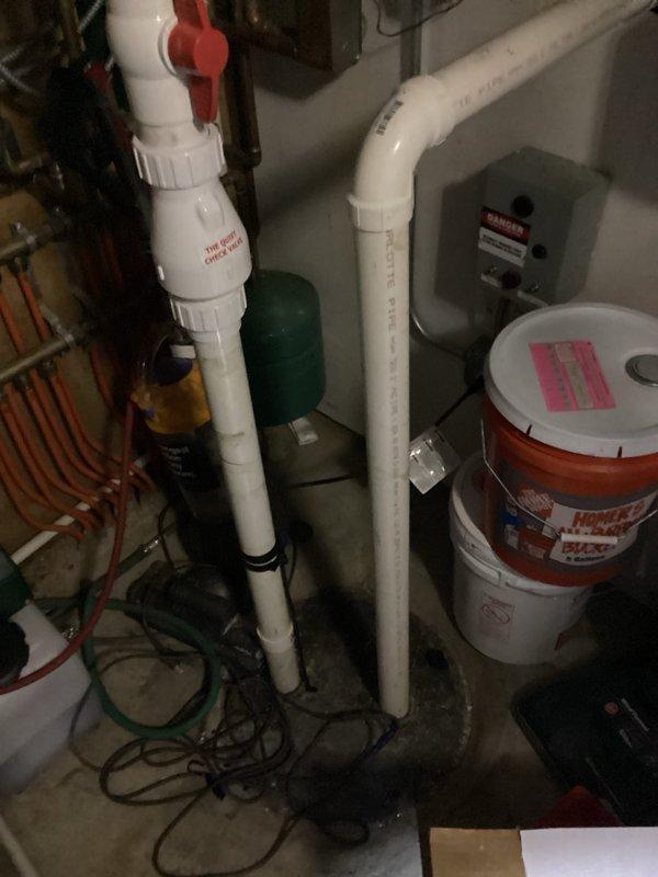 Responded to service call for Duravit in-wall toilet with sticking flush mechanism causing continuous water running. Diagnosed faulty flush actuator components requiring replacement parts and performed inspection of ejector pump system. Verified sump pump installation, check valve operation, and discharge piping assembly for proper functionality during comprehensive basement plumbing system evaluation.