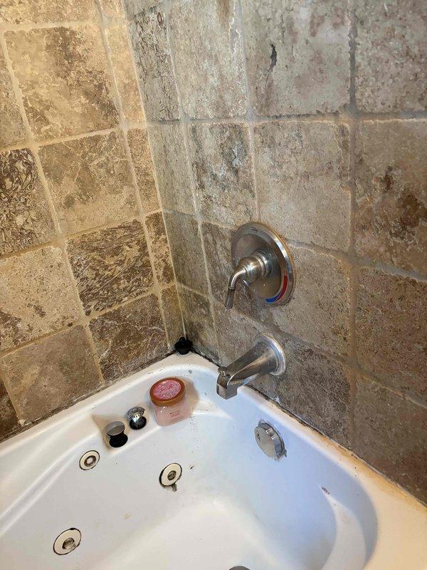 Conducted on-site assessment for replacement of existing 58x30 jetted whirlpool bathtub with standard soaking tub. Evaluated current installation including chrome fixtures, stone tile surround, and plumbing connections to determine scope of work for future tub replacement. Documented existing jetted tub configuration and surrounding tile work to provide accurate estimate for removal and installation of traditional bathtub unit.