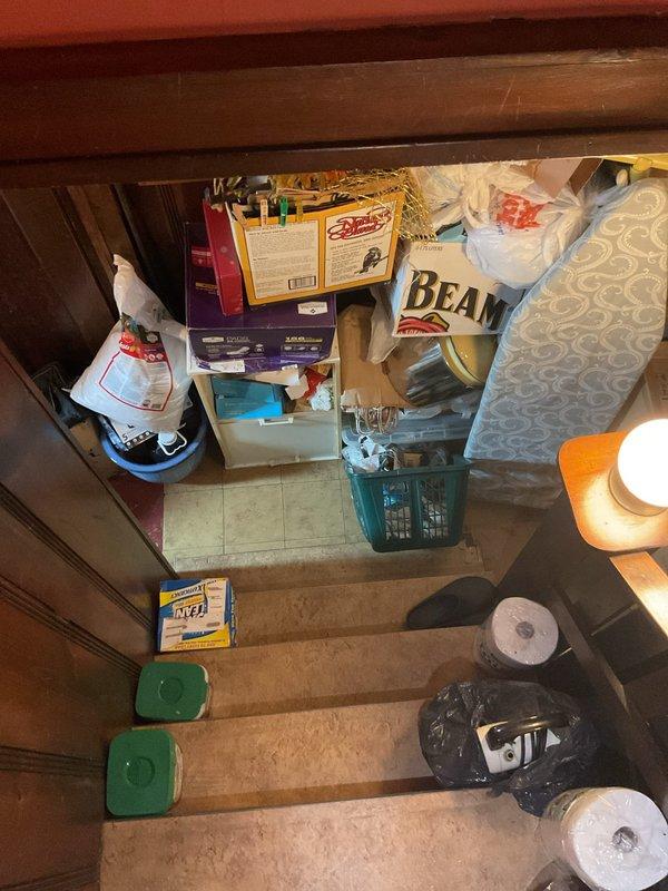 Scheduled return visit to install 50-gallon tall water heater per customer specifications. Access assessed via interior stairwell and landing area; installation pathway and clearances documented photographically for equipment delivery and positioning logistics.