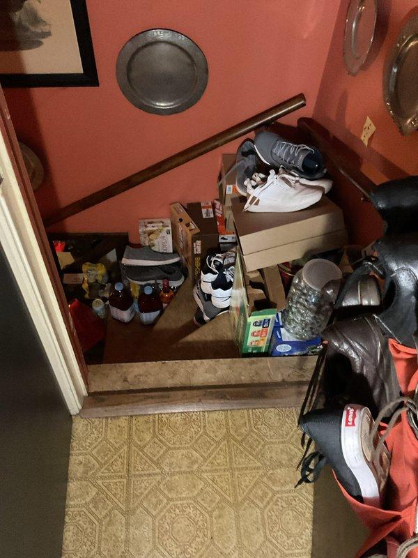 Scheduled return visit to install 50-gallon tall water heater per customer specifications. Access assessed via interior stairwell and landing area; installation pathway and clearances documented photographically for equipment delivery and positioning logistics.