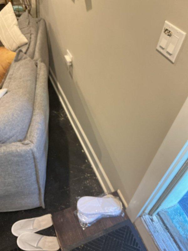 Responded to service call for basement water seepage occurring during rainfall at foundation wall corner and replaced broken bathroom sink drain stopper. Inspected exterior doorway threshold and identified water damage, staining, and potential mold growth at door frame junction, indicating compromised weatherproofing allowing moisture intrusion. Examined interior basement corner where seepage was reported and documented existing conditions. Successfully replaced defective pop-up drain stopper assembly in bathroom sink, restoring proper drainage function.