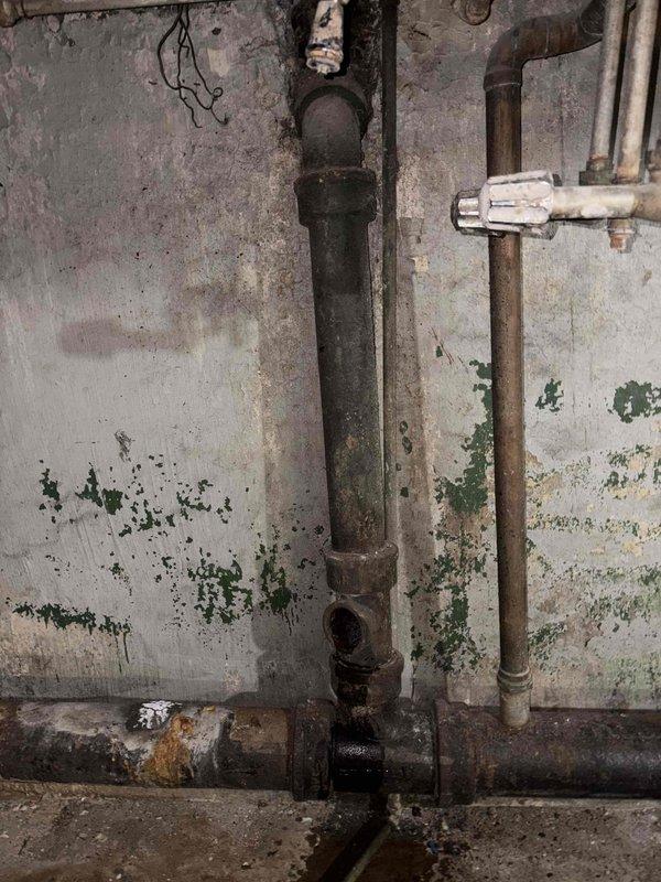 Responded to commercial facility for leaking 6-inch cast iron drain pipe in basement. Upon arrival, conducted thorough inspection of the deteriorated plumbing infrastructure. Found extensive corrosion and rust throughout the cast iron piping system, with active leak present at pipe joints. Wall surfaces showed significant moisture damage and deterioration from prolonged water exposure. Documented existing conditions through photographic evidence showing corroded cast iron vertical and horizontal pipe runs with failing threaded connections, adjacent galvanized piping, and compromised wall surfaces. Provided comprehensive estimate for cast iron pipe replacement and associated piping repairs to address the leak and prevent further water damage to the facility's basement structure.