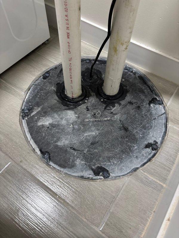 Completed ejector pump replacement installation in basement utility room, including new sump basin, PVC discharge piping with proper venting configuration, and dedicated GFCI electrical outlet with weatherproof enclosure. Installed floor penetration seal plate where discharge piping passes through flooring to upper level, and coordinated wall opening for final inspection access as required by local code.