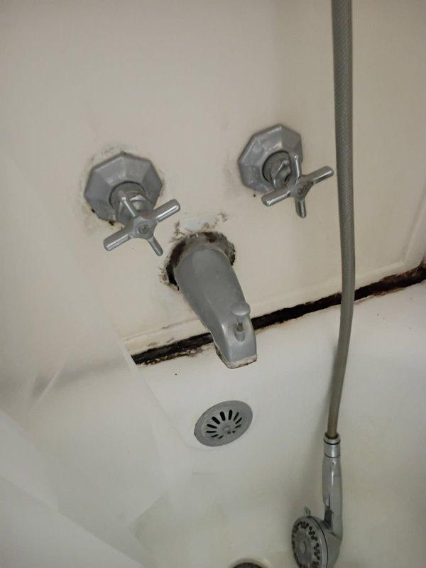 Responded to a leaking double-handle shower faucet in a VIP service call. Replaced both worn cartridges in the wall-mounted cross-handle controls to restore proper water flow and eliminate the leak. The fixtures showed signs of age with visible corrosion and staining around the mounting points, and the repair successfully resolved the reported water leakage issue.