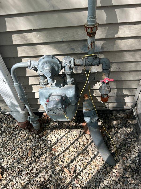 Responded to service call for gas line repair and pressure testing at residential property. Upon arrival, inspected exterior gas meter assembly and discovered corroded piping and deteriorated connections showing significant rust damage on multiple components. Performed gas line repair by replacing compromised sections of pipe and corroded fittings to restore system integrity. Conducted pressure test on repaired gas line to verify no leaks were present and system met safety standards. All connections tested and confirmed secure with proper gas flow restored to the residence.