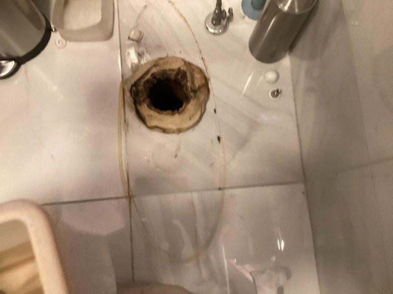 Responded to customer complaint of sewer smell in bathroom and bedroom caused by faulty toilet seal. Upon inspection, identified compromised wax ring seal at toilet base allowing sewer gases to escape into living areas. Removed and replaced defective wax ring with new seal, ensuring proper compression and gas-tight connection between toilet flange and fixture. Verified secure mounting, tested flush operation, and confirmed elimination of odor issue upon completion.
