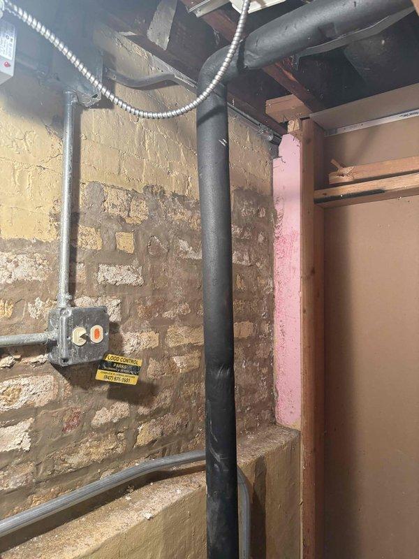 Completed plumbing estimate for whole home water filtration system installation in residential property. Assessed existing plumbing infrastructure in unfinished basement area, including exposed piping, shut-off valves, and electrical conduit routing. Documented current conditions of water supply lines, drainage systems, and available mounting locations on painted masonry walls near existing mechanical systems to determine optimal placement and connection points for life source filtration unit.