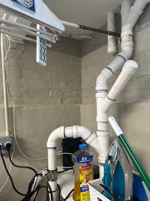 Completed toilet installation in residential property during morning appointment. Installation included connecting new fixture to existing plumbing infrastructure, with work performed in utility room area featuring PVC drainage system and pump assembly. All connections tested and verified operational upon completion.