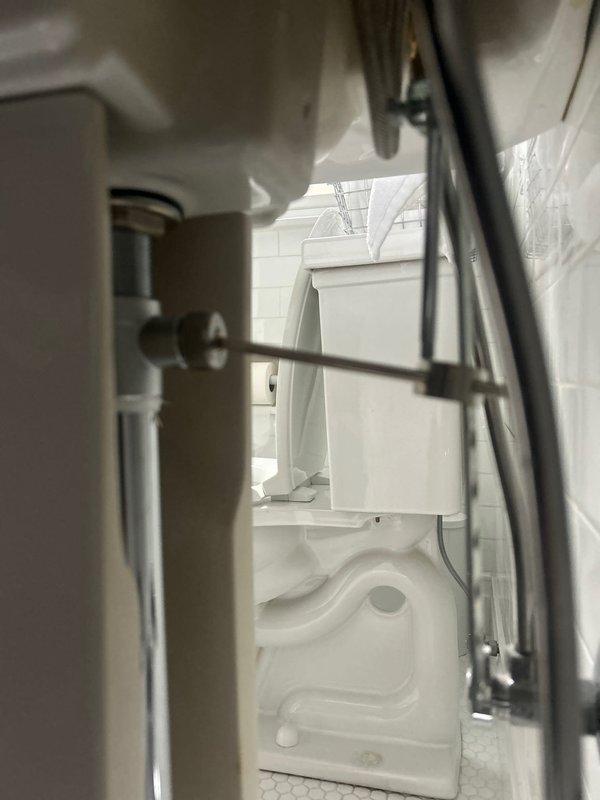 Responded to multiple plumbing concerns including slow draining fixtures and noisy plumbing. Inspected upstairs bathroom shower assembly, bathtub fixtures, and drainage system where customer reported unusual noise during shower operation. Evaluated kitchen faucet experiencing loud operational noise and assessed upstairs bathroom vanity marked for replacement. Documented existing plumbing infrastructure including water heater connections and supply lines in utility area to determine source of drainage issues and fixture noise complaints.