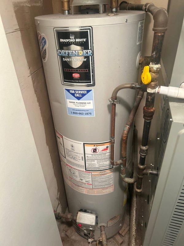 Responded to service call for ceiling water leak and loss of hot water. Upon inspection, located Bradford White Defender Safety System water heater in utility area. Documented visible ceiling damage with paint and surface material deterioration in affected room, indicating active water intrusion from above. Examined water heater installation including all copper piping connections, gas control valve, and plumbing fixtures. Photographed unit specifications, manufacturer labels, and surrounding installation area for diagnostic purposes. Identified water heater as probable source of leak based on location correlation with ceiling damage and simultaneous loss of hot water function. Recommended immediate water heater repair or replacement to resolve both the active leak and restore hot water service.