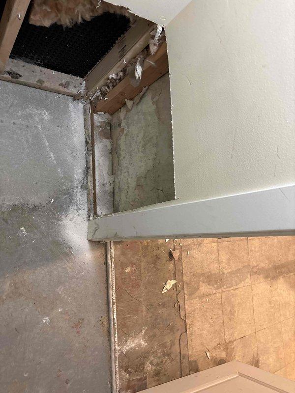 Responded to water leak originating from recently installed drain tile system at foundation level. Upon arrival, discovered active moisture intrusion at the junction where drain tile meets foundation wall, causing water damage to interior basement walls and ceiling materials. Identified compromised waterproofing membrane seal at corner transition point between existing concrete foundation and dimpled drainage membrane. Inspected deteriorated concrete surfaces showing vertical cracking, spalling, and moisture staining, along with visible mold growth on wall surfaces. Assessed damaged ceiling materials and exposed structural elements affected by water infiltration. Documented extensive water damage including discolored drywall, compromised particle board, and deteriorated wall finishes. Collected remaining balance payment for previous drain tile installation work. Photographic documentation captured for insurance and warranty purposes showing foundation corner conditions, membrane instal
