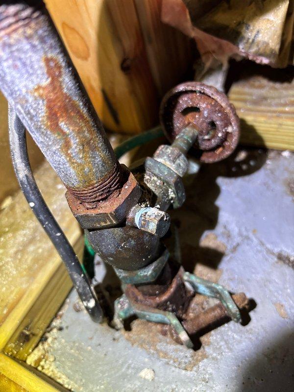 Replaced severely corroded water meter assembly and associated galvanized piping showing extensive rust, oxidation, and mineral buildup. The existing installation exhibited significant deterioration including green patina on brass fittings, heavy rust on galvanized components, and water damage to surrounding wooden platform. Coordinated city water shut-off to safely remove and replace the compromised meter, valve assembly, and connecting pipes with new components to restore proper water service and prevent potential leaks or failures from the aged plumbing system.