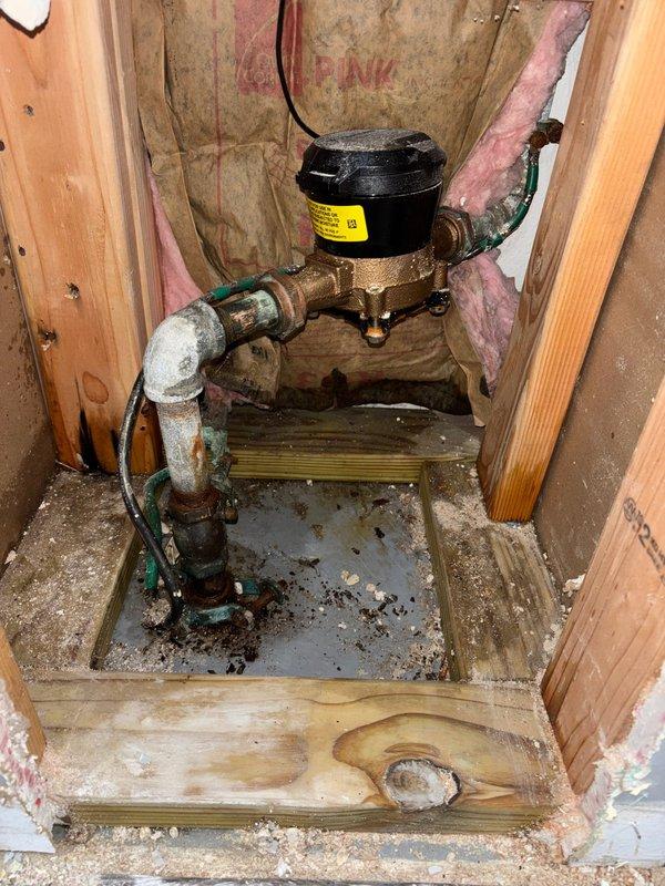 Replaced severely corroded water meter assembly and associated galvanized piping showing extensive rust, oxidation, and mineral buildup. The existing installation exhibited significant deterioration including green patina on brass fittings, heavy rust on galvanized components, and water damage to surrounding wooden platform. Coordinated city water shut-off to safely remove and replace the compromised meter, valve assembly, and connecting pipes with new components to restore proper water service and prevent potential leaks or failures from the aged plumbing system.