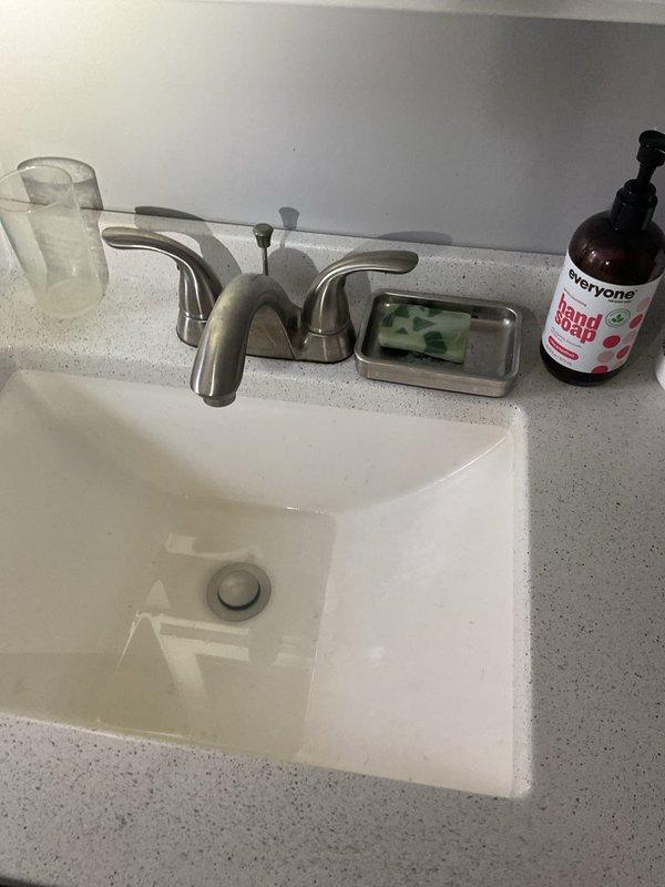 Responded to bathroom sink clog located beyond the P-trap in the drain line. Upon inspection, verified blockage was not accessible through standard P-trap removal and required snaking equipment to clear the obstruction. Successfully cleared the drain line using appropriate cable snake tools, restoring full drainage function to the bathroom sink fixture.