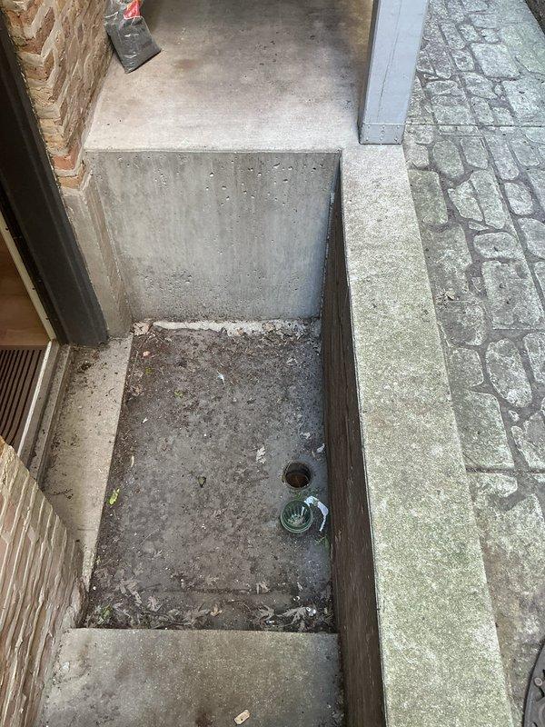 Conducted site assessment of exterior gangway drainage system and provided estimate for floor drain installation and cleanout access point. Documented existing conditions showing accumulated debris in concrete utility pit with deteriorated drain cover, and evaluated optimal placement for new cleanout to improve drainage functionality and maintenance accessibility.