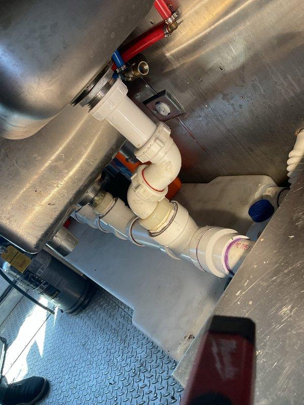 Responded to emergency plumbing call for failed water pump replacement and leaking PVC drain fittings. Successfully installed new water pump assembly with proper PVC piping configuration, including inlet and outlet connections with appropriate valves and fittings. Addressed improperly sealed sink drain connections where PVC fittings had become over-tightened, causing stress cracks and water seepage. Disassembled affected drain sections, cleaned and inspected all connection points, and reinstalled with proper primer and solvent cement application to ensure watertight seals. Verified pump operation and tested all drain connections under pressure to confirm no leaks. System restored to full functionality with all components properly secured and sealed.