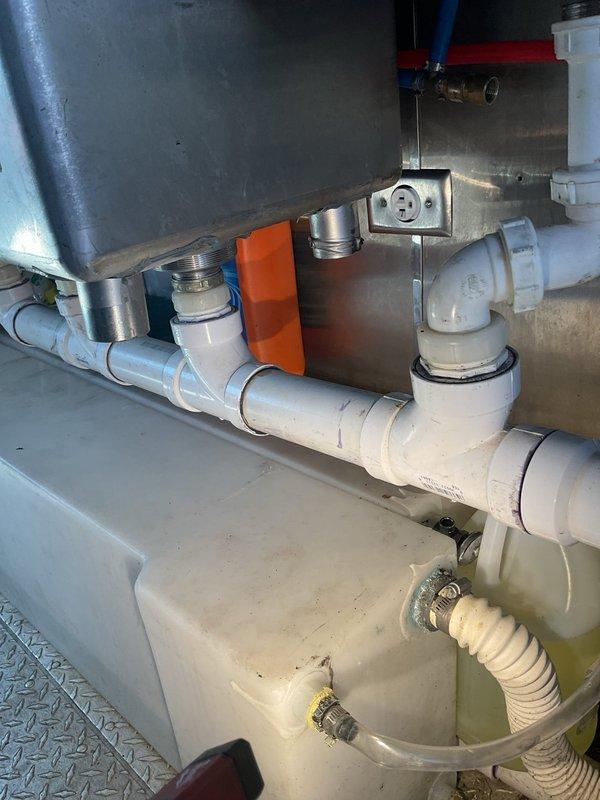 Responded to emergency plumbing call for failed water pump replacement and leaking PVC drain fittings. Successfully installed new water pump assembly with proper PVC piping configuration, including inlet and outlet connections with appropriate valves and fittings. Addressed improperly sealed sink drain connections where PVC fittings had become over-tightened, causing stress cracks and water seepage. Disassembled affected drain sections, cleaned and inspected all connection points, and reinstalled with proper primer and solvent cement application to ensure watertight seals. Verified pump operation and tested all drain connections under pressure to confirm no leaks. System restored to full functionality with all components properly secured and sealed.
