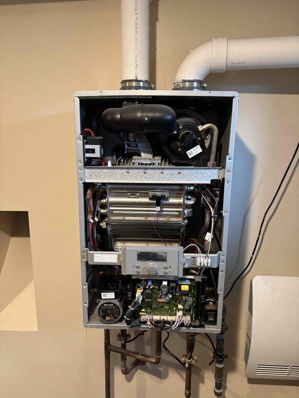 Responded to service call for Rheem Performance Platinum tankless water heater (Model# ECOH200DVRHLN) experiencing leak and no hot water production. Upon inspection, accessed internal components and identified circulation pump failure causing system malfunction. Replaced defective circulation pump assembly, tested all connections for proper operation, verified heat exchanger integrity, and confirmed system parameters were within manufacturer specifications. Unit restored to full operational status with proper hot water delivery and no active leaks detected.