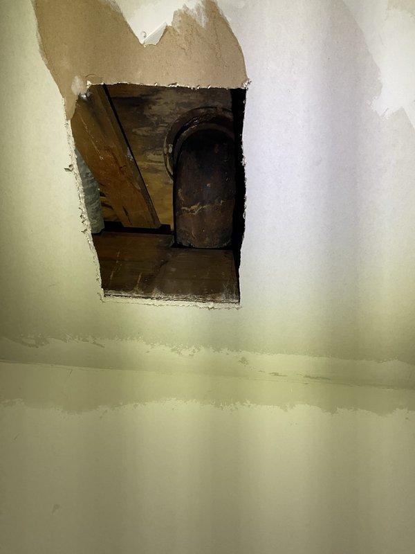 Responded to priority service call for toilet repair in residential bathroom. Customer had attempted DIY wax ring replacement but encountered spinning closet bolts that prevented nut removal. Upon arrival, assessed two-piece white porcelain toilet with corroded closet bolt assembly. Used rotary cutting tool to remove seized closet bolts that could not be loosened conventionally. Removed toilet from floor flange, scraped old wax ring residue from both toilet base and floor flange, and inspected flange for damage. Installed new wax ring with integrated flange sleeve for improved seal. Secured toilet to floor using new brass closet bolts and washers, ensuring proper alignment and level positioning. Tightened mounting nuts to manufacturer specifications to prevent rocking while avoiding over-compression of porcelain base. Reconnected water supply line and tested flush mechanism for proper operation. Verified seal integrity by checking for water leakage at base during multiple flush cycles.