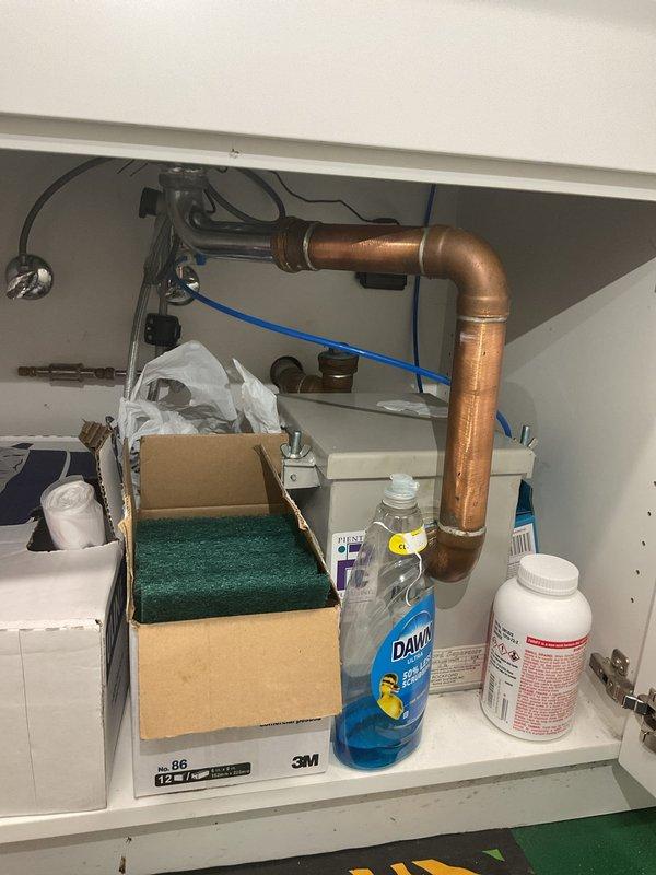 Responded to a drain backup issue affecting two bathrooms where water was coming up through floor drains. Inspected the accessible bathroom with floor drain and under-sink plumbing in the kitchen area. Identified blockage in the main drain line causing wastewater to reverse flow through floor drains in both bathroom locations. Cleared the obstruction using professional drain cleaning equipment, restoring proper drainage flow throughout the system. Tested all affected drains to confirm complete clearance and verified no further backup issues.