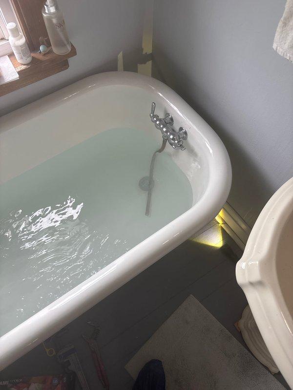 Responded to warranty callback for leaking waste and overflow assembly on freestanding bathtub. Upon inspection, identified leak at overflow connection when tub was filled to capacity. Disassembled waste and overflow assembly, resealed connections with plumber's putty, tightened all compression fittings, and tested system under full water load to verify proper seal and drainage function.