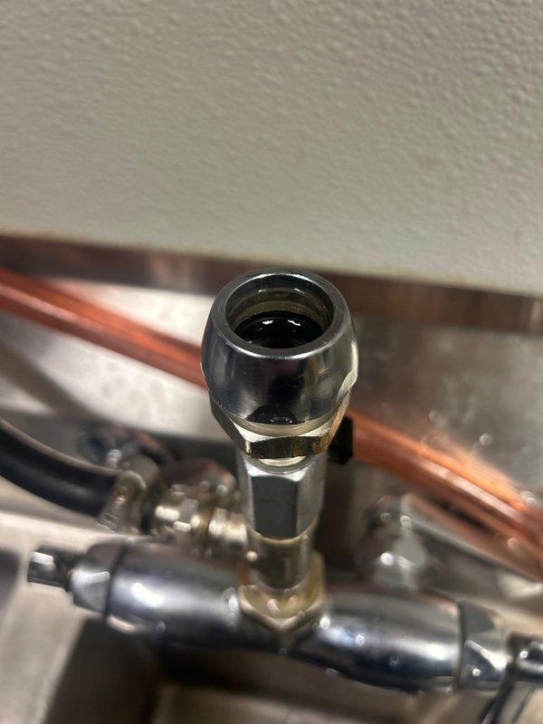 Responded to a commercial kitchen plumbing emergency where the sink faucet assembly had completely broken off from the mounting point. Replaced the failed chrome pull-out spray faucet unit, reconnected copper supply lines with new brass compression fittings, and installed replacement flexible hoses to restore full water service to the stainless steel sink basin.