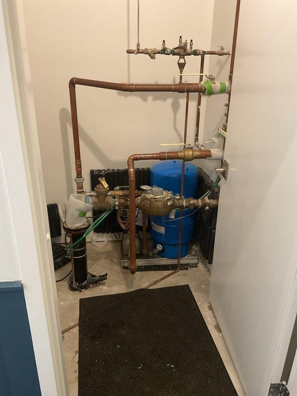 Installed new recirculation pump assembly with associated copper piping, valves, and pressure gauge to existing water heater system. Configured pump with ribbed inlet connections and integrated brass manifold assembly to optimize hot water delivery throughout the residence, eliminating wait times for hot water at fixtures.
