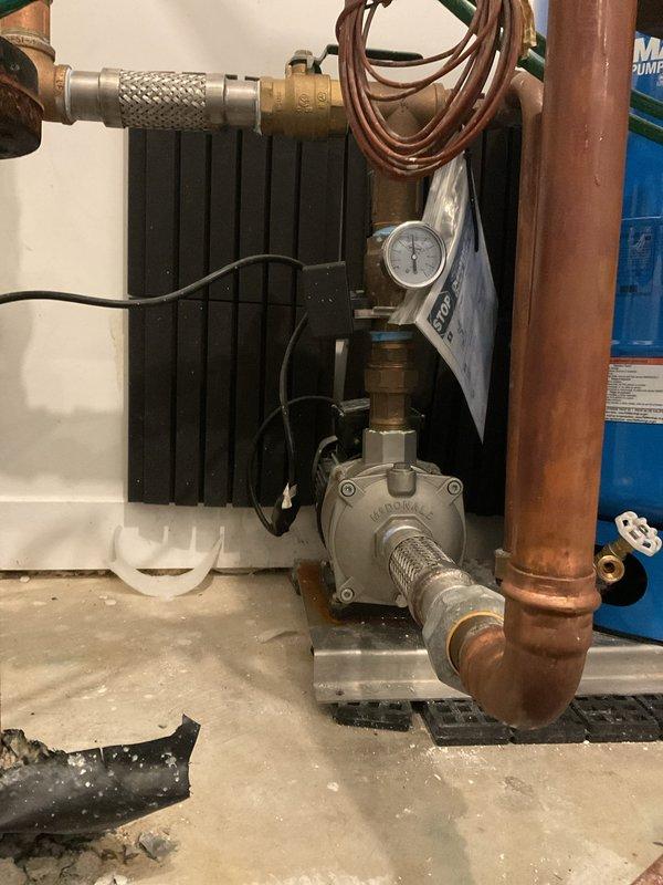 Installed new recirculation pump assembly with associated copper piping, valves, and pressure gauge to existing water heater system. Configured pump with ribbed inlet connections and integrated brass manifold assembly to optimize hot water delivery throughout the residence, eliminating wait times for hot water at fixtures.