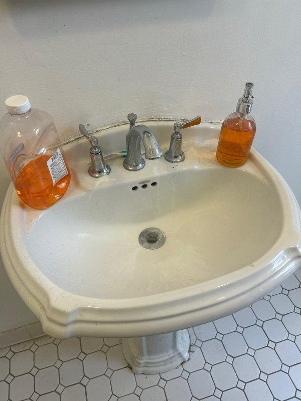 Responded to water leak service call and conducted thorough inspection of bathroom plumbing fixtures. Examined pedestal sink with widespread faucet configuration and bathtub with wall-mounted spout and overflow drain assembly. Identified source of water intrusion, performed necessary repairs to affected plumbing components, and verified proper drainage function. All fixtures tested and confirmed operational with no active leaks detected upon completion.