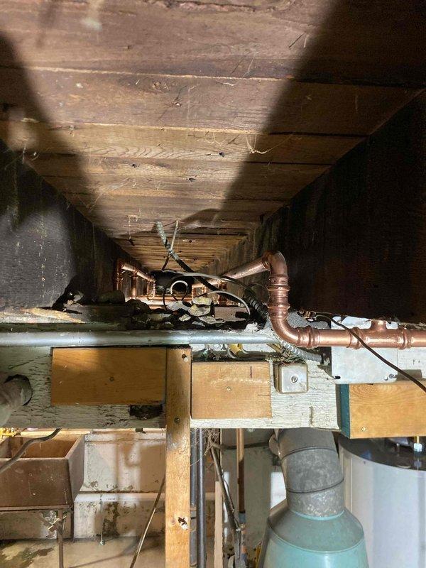 Completed comprehensive plumbing system inspection and assessment in crawl space and basement mechanical room. Evaluated copper supply lines, water heater installation, pressure tank, and water treatment equipment. All systems photographed and documented for repair proposal, with findings presented to customer for approval of recommended work.