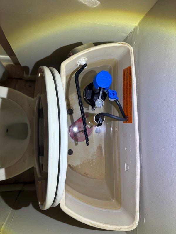 Responded to Unit 1F for reported toilet leak at base. Upon inspection, removed tank lid and assessed internal components and floor connection. Tank interior showed mineral buildup and sediment accumulation on porcelain surfaces. Examined wax ring seal, closet bolts, and floor flange connection point where leak originated. Completed necessary repairs to eliminate water seepage from toilet base, ensuring proper seal between fixture and floor flange. Verified all tank components functioning correctly and confirmed no active leaking upon completion.