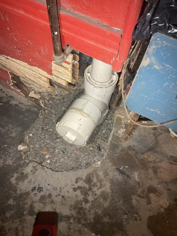 Completed main line drain and sewer installation in crawl space and basement area. Installed new PVC drainage piping system with proper fittings and connections through floor and wall penetrations. Addressed deteriorated conditions in utility space including water-damaged concrete flooring and compromised wooden structural elements. System approved for financing and scheduled for final inspection.