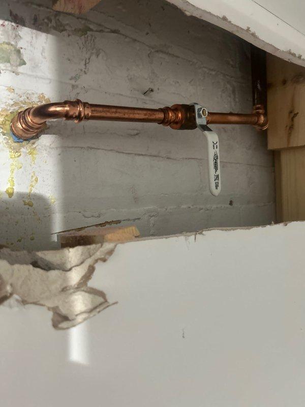 Conducted a comprehensive drain and sewer system evaluation for a commercial property, focusing on aging plumbing infrastructure in the basement utility area. Assessment revealed copper piping with significant oxidation and patina buildup, multiple 90-degree elbow joints requiring inspection, and wall-mounted fixtures showing signs of age-related deterioration. Documented existing conditions including concrete floor cracking, water staining on concrete block walls, and utility connection points for future maintenance planning and estimate preparation.