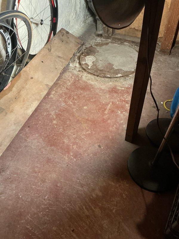 Responded to service call for catch basin cleaning in basement utility area. Upon arrival, located catch basin in corner of basement with visible deterioration and corrosion throughout interior pipe walls. Basin contained standing water with debris accumulation and sediment buildup along edges. Performed thorough cleaning of catch basin, removing debris, sediment, and buildup from interior surfaces. Documented pre-service and post-service conditions with photographs showing extent of corrosion and water accumulation. Basin restored to proper drainage function.