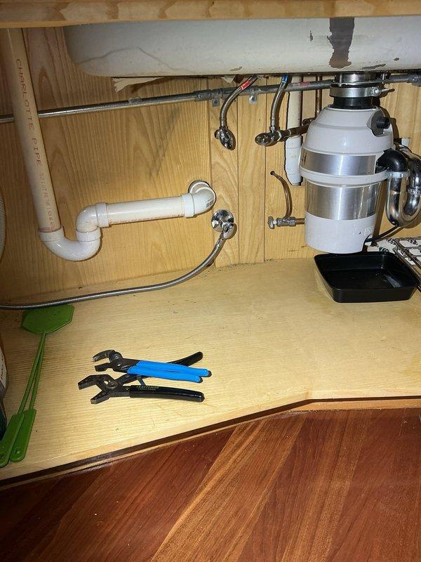 Responded to kitchen sink drainage issue where water was backing up within 45 seconds during testing. Client reported heavy usage of island sink during cooking the previous day resulted in complete blockage. Protected work area with plastic sheeting and accessed cabinet space beneath sink to assess plumbing configuration. Power rodded the kitchen sink drain line to clear the obstruction and restore proper drainage flow. Verified P-trap and garbage disposal connections were secure following rodding procedure. Tested system to confirm blockage was fully cleared and water drained freely without backup.