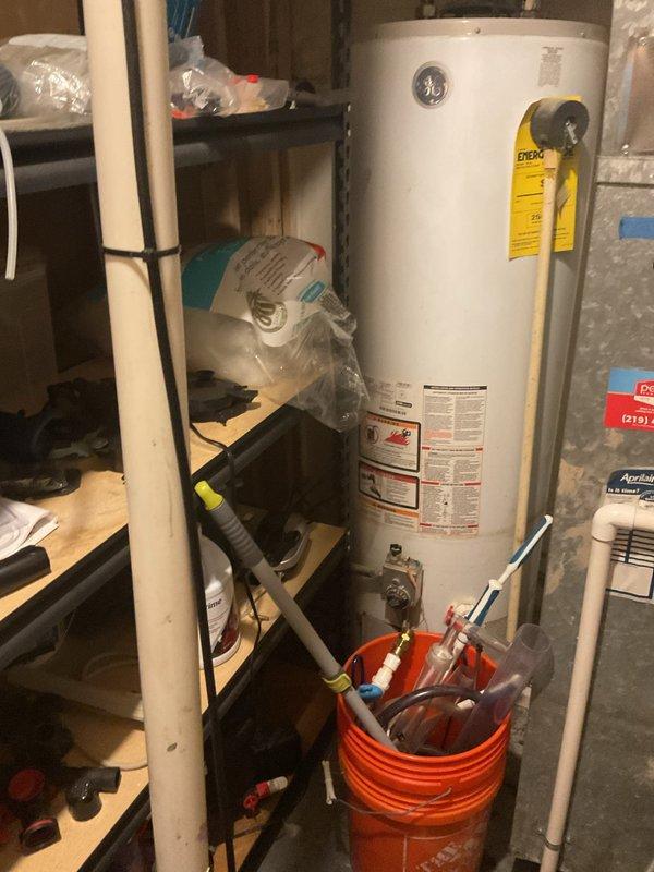 Removed existing 50-gallon conventional storage tank water heater from utility room and successfully installed new tankless water heating system. Installation included proper venting configuration, gas line connections, water supply line modifications, and electrical wiring to meet manufacturer specifications and local code requirements.