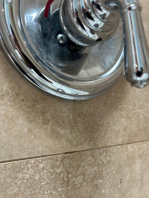 Responded to priority service call for multiple plumbing issues including two showers with leaking hand sprayers, a third shower with mixing valve leak upon activation, and loud noise occurring during toilet flushing. Inspected chrome-plated shower fixtures and identified leak points at hand sprayer connections and mixing valve assembly. Examined toilet installations and plumbing system to diagnose source of water hammer noise during flush cycles. Documented conditions of bathroom fixtures including toilet, vanity plumbing connections with copper supply lines, and shower components for assessment. Provided estimates for replacement of four toilets as requested by customer.