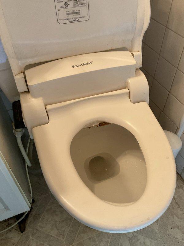 Responded to service call for malfunctioning shut off valve behind toilet. Upon arrival, inspected the angle stop valve supplying water to the toilet fixture equipped with SmartBidet attachment. Replaced the defective shut off valve with new quarter-turn angle stop valve, ensuring proper connection to existing water supply line and flexible braided supply hose. Tested valve operation for smooth shut-off capability and checked all connections for leaks. Restored water supply and verified proper flow to toilet and bidet unit without any water seepage.