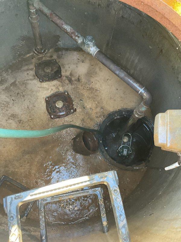 Completed comprehensive VIP maintenance service including sump pump pit inspection, basin evaluation, and plumbing system assessment. Inspected sump pump operation and discharge system, noting existing pump unit with green discharge hose in active concrete basin with accumulated sediment and standing water. Evaluated basin condition, including corroded galvanized piping, metal flanges, and mounting hardware showing age-related deterioration. Performed hands-on maintenance of pump components and basin cleaning in wet conditions, addressing water accumulation and sediment buildup on concrete surfaces. All plumbing connections, fittings, and discharge systems were inspected for proper operation and documented with photographic evidence.