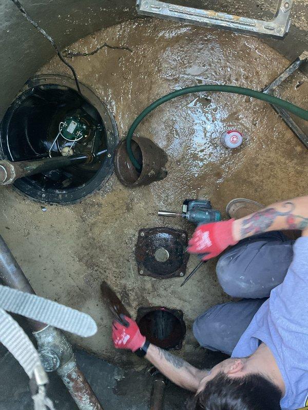 Completed comprehensive VIP maintenance service including sump pump pit inspection, basin evaluation, and plumbing system assessment. Inspected sump pump operation and discharge system, noting existing pump unit with green discharge hose in active concrete basin with accumulated sediment and standing water. Evaluated basin condition, including corroded galvanized piping, metal flanges, and mounting hardware showing age-related deterioration. Performed hands-on maintenance of pump components and basin cleaning in wet conditions, addressing water accumulation and sediment buildup on concrete surfaces. All plumbing connections, fittings, and discharge systems were inspected for proper operation and documented with photographic evidence.