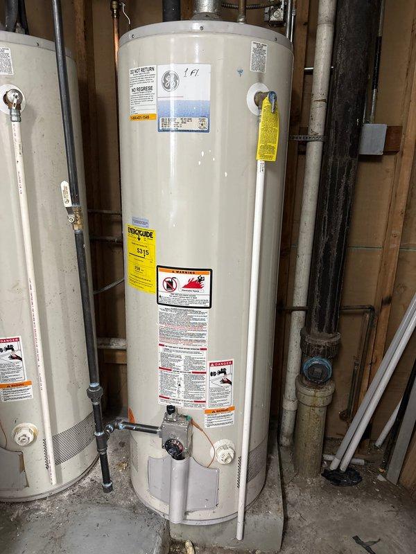 Responded to gas leak detected by utility company at water heater gas valve connection. Inspected gas control assembly, valve connections, and supply piping. Documented existing water heater installation and gas control components for warranty service verification.