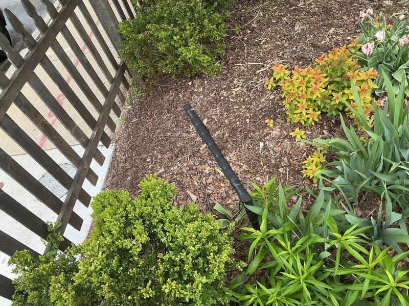 Responded to priority service call for outdoor water supply issue. Activated water supply from municipal buffalo box at sidewalk and investigated reported leak in supply line between city connection and garden valve. Documented irrigation system layout and garden bed area showing drip line configuration and landscaping conditions for leak assessment purposes.