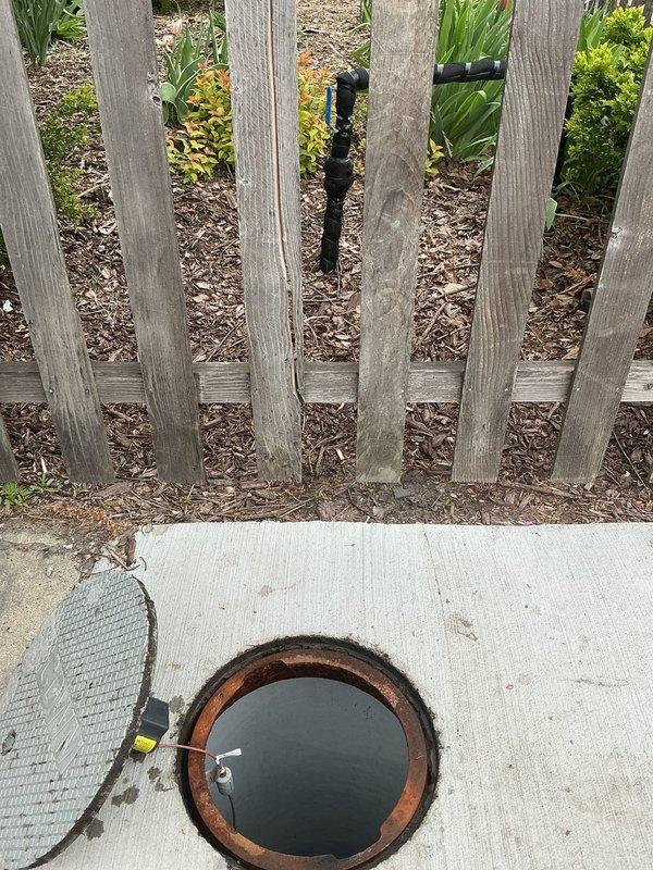Responded to priority service call for outdoor water supply issue. Activated water supply from municipal buffalo box at sidewalk and investigated reported leak in supply line between city connection and garden valve. Documented irrigation system layout and garden bed area showing drip line configuration and landscaping conditions for leak assessment purposes.